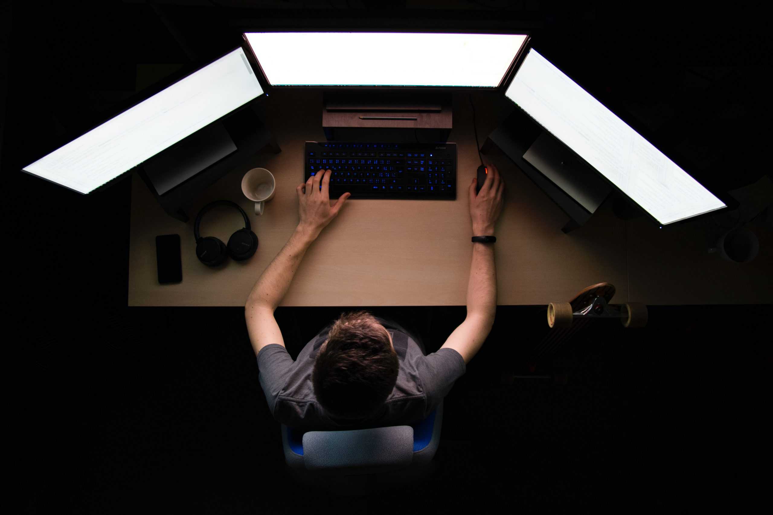 Birds eye view of a person using a on computer in a dark room